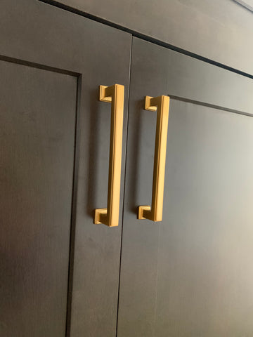 satin brass cabinet pulls on black cabinet